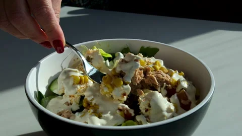 Salad fork dressing Bowl with salad with tuna, corn, parmesan cheese, tomatoes Stock Footage 314099444