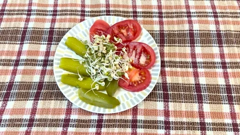 Salad of fresh vegetables and micro-greenery. Tomatoes, apples, pickles, finely Stock Footage 271406933