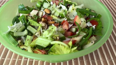 Salad with fresh vegetables like celery, tomatoes, cucumbers, garlic arrows Stock Footage 274959149