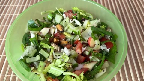 Salad with fresh vegetables like celery, tomatoes, cucumbers, garlic arrows Stock Footage 300053892