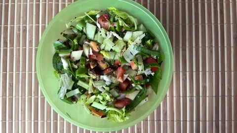Salad with fresh vegetables like celery, tomatoes, cucumbers, garlic arrows Stock Footage 300054002