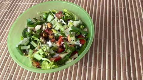 Salad with fresh vegetables like celery, tomatoes, cucumbers, garlic arrows Stock Footage 316806936