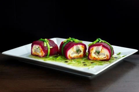 Salad with herring, beets, carrots, onions, potatoes and eggs on a plate. Photos
