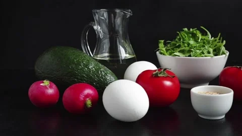 Salad ingredients boiling egg tomatoes avocado arugula olive oil radish Stock Footage 113755775