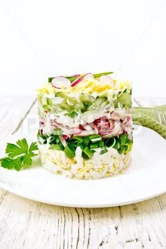 Salad layered with radish and cucumber on board Stock Photos