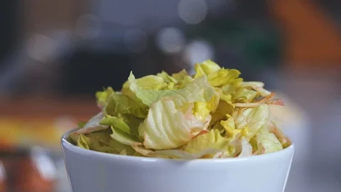 Salad leaves fall into the plate Stock Footage 103985403