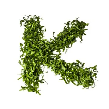 Salad letter k on white background Stock Photos