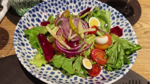 Salad with lettuce, beetroot, tomato, eggs and a pickle vinaigrette. Stock Footage 331782054