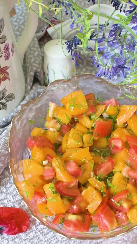 A salad is made with fresh red and yellow tomatoes, young garlic and dill. .. Stock-Footage 338407789