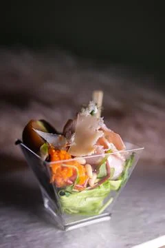 Salad with meat and nuts in a plastic cup on the buffet Stock Photos