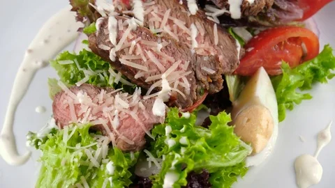 Salad with meat, close-up view, sliced grilled beef steak with parmesan cheese Stock Footage 81004274