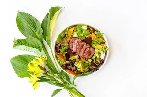 Salad with medium roasted beef and greens on a white background Stock Photos