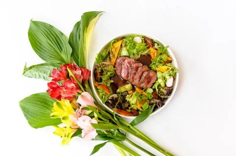 Salad with medium roasted beef and greens on a white background Stock Photos