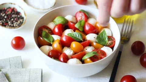 Salad with mozzarella, tomatoes and basil. Healthy eating. Vegetarian food. Stock Footage 196905329