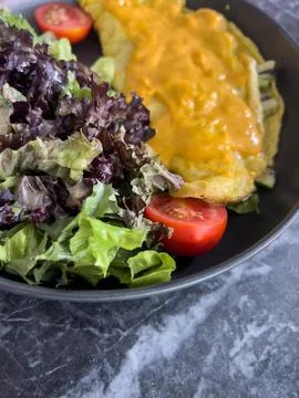 Salad with omelette on table Stock Photos