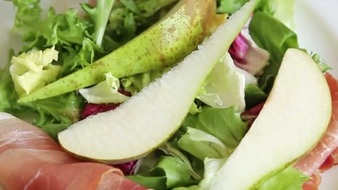 Salad pear ham vegetable dish fresh tasty gourmet food Stock Footage 306780449