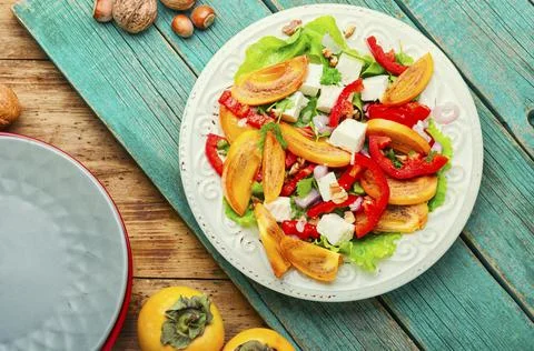 Salad with persimmon Stock Photos