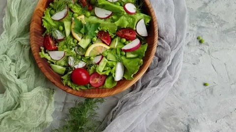 Salad in a plate on a background, slow motion Video stock 154938335