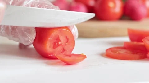 Salad preparation, cut tomatoes on a plastic cutting board Stock Footage 241585344