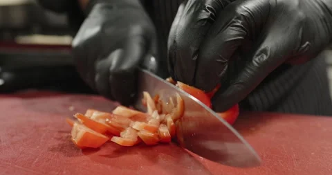 Salad preparation. Professional chef chops juicy red bell pepper on the cutting Stock Footage 275620624