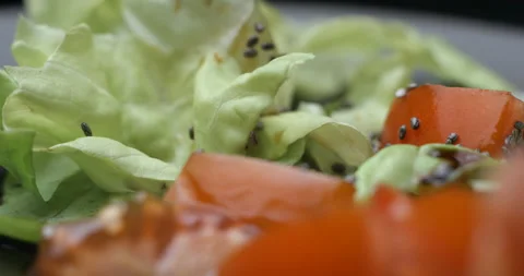 Salad preparing macro with herbs and chia seeds slowmotion Video stock 137924809