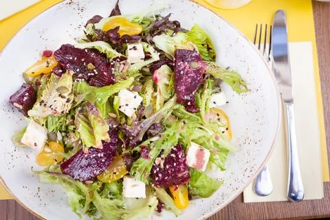 Salad of roasted beetroot, pear, spinach, hard cheese,..walnuts and quince Stock Photos