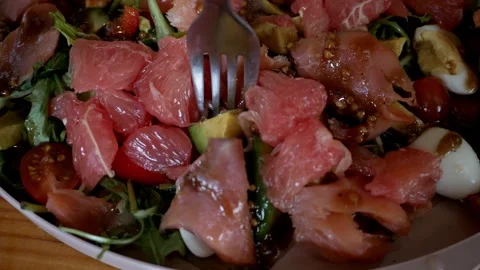 Salad - salmon, arugula, grapefruit, cherry tomatoes, quail eggs, avocado. Close Stock Footage 275875927