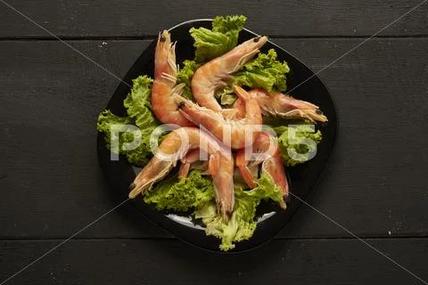 Salad with shrimp on the plate in cafe Stock Photos