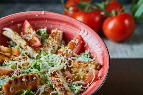 Salad with slice of chicken with cheese and tomatoes Stock Photos