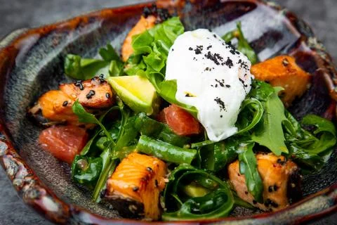 Salad with spinach, eel, lime, sour cream, side view Stock Photos