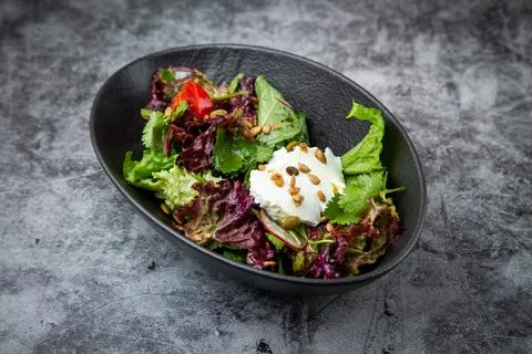 Salad with spinach, eel, lime, sour cream, side view Stock Photos