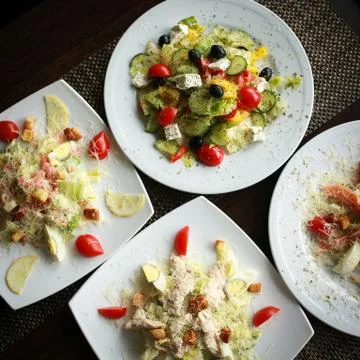 Salad top view. Plates on table. Food photography concept. Healthy diet. Square Stock Photos