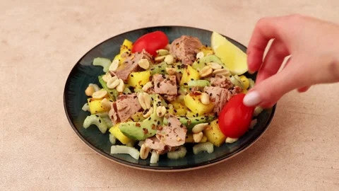 Salad with tuna, tomatoes, peanuts, mango, avocado, celery, chili and sesame. Stock Footage 283104506