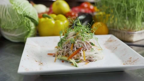 Salad of vegetables, meat, pea sprouts, noodles. Rotating background. Stock Footage 190865381