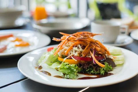 Salads vegetable breakfast served with eggs, ham, orange juice and delicious. Stock Photos