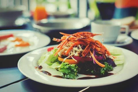 Salads vegetable breakfast served with eggs, ham, orange juice and delicious. Stock Photos