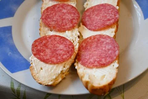 Salami bread rolls with creamy spread on a plate 스톡 사진