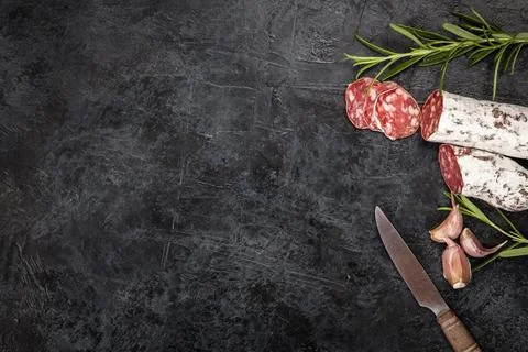 Salami on dark background Stock Photos