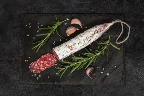Salami on dark background Stock Photos