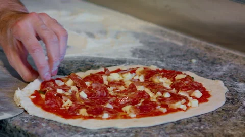 Salami dough and cheese. Throw a pizza on a kitchen oven shovel. Stock Footage 159339315