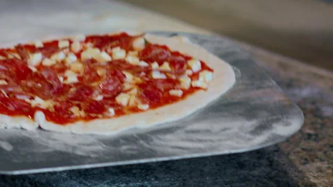 Salami dough and cheese. Throw a pizza on a kitchen oven shovel. Stock Footage 159339348