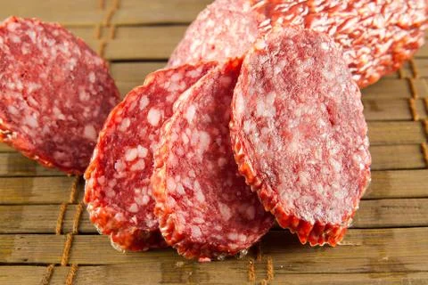 Salami isolated on a vintage background Stock Photos