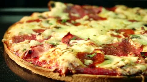 Salami pizza baking in the oven (close-up) Stock-Footage 24673324