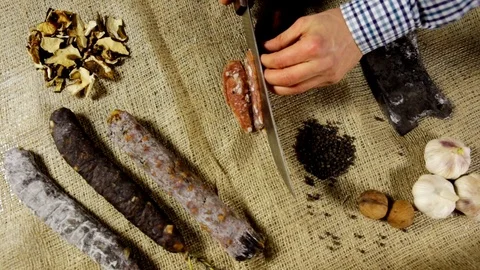 Salami sausage is being cut to tiny slices Stock Footage 102586288