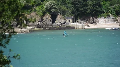 Salcombe, Devon, UK - 15 July 2023: Surfer Wing foiling at Salcombe Harbour Stock Footage 246147849