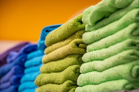 Sale of bath towels in the store. Stack of spa accessories. Fotos Stock