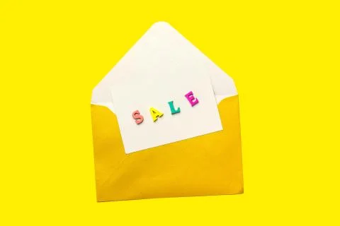 Sale note in an open envelope isolated on yellow background Stock Photos