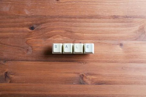 Sale word concept on computer keyboard keys buttons on a wooden background. Stock Photos