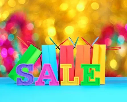 Sale written by colorful letters on the background of shopping bags Stock Photos