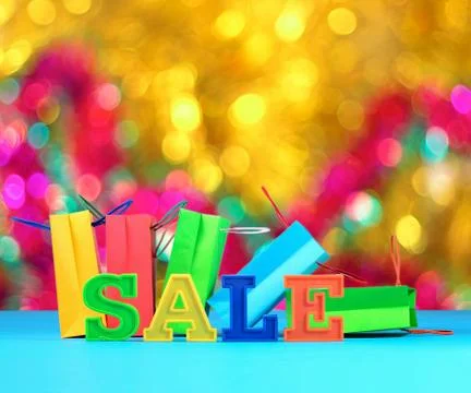 Sale written by colorful letters on the background of shopping bags Stock Photos